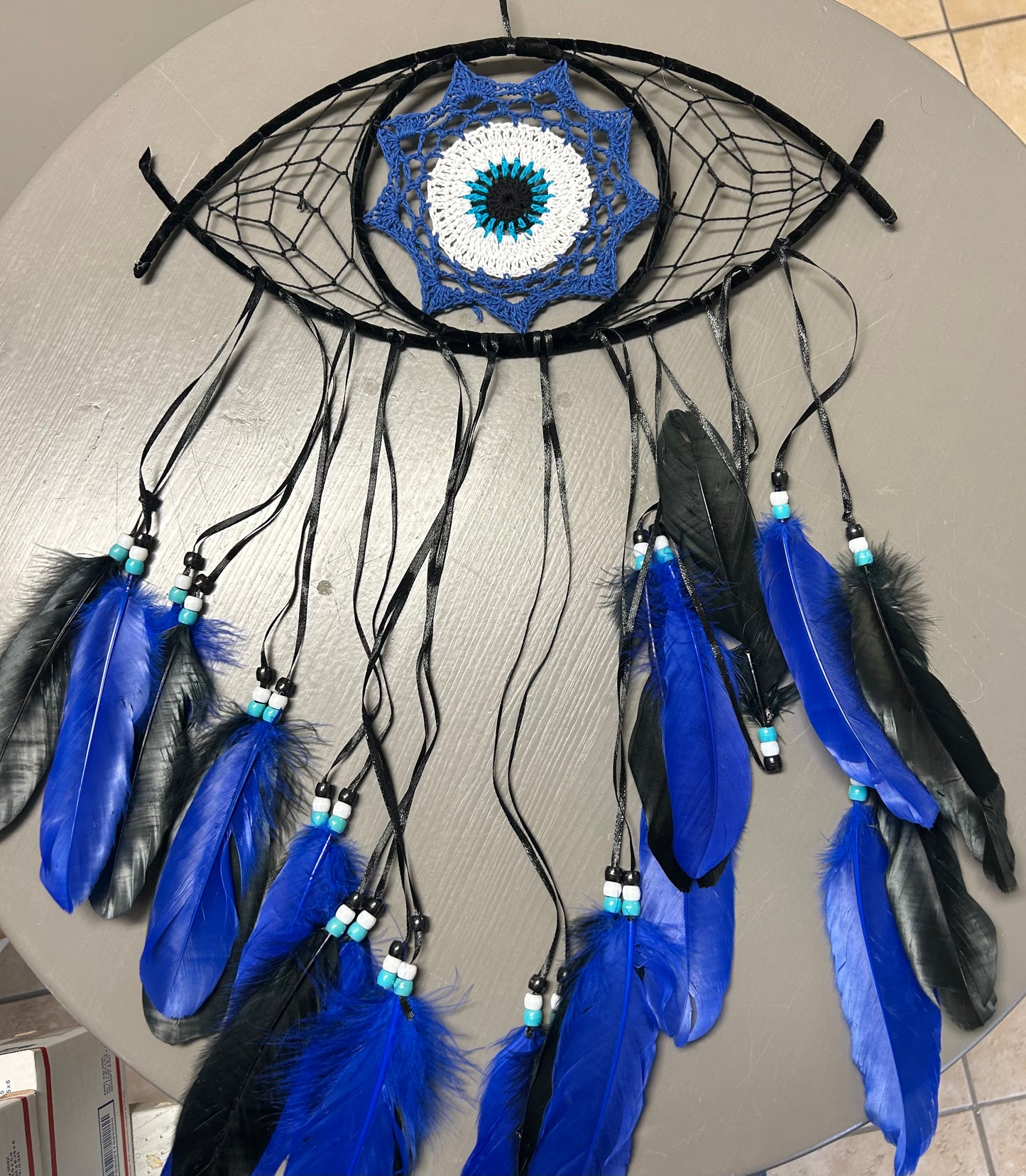 Large Eye Shaped Dream Catcher Featuring Crochet Evil Eye Center and Blue Feathers